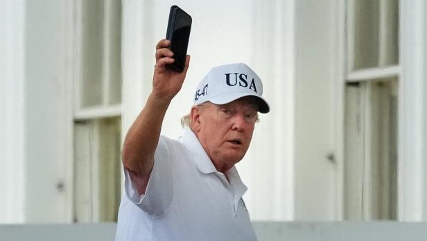 U.S. President Donald Trump gestures as he enters the White House