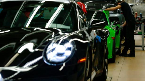 FILE PHOTO: Employees of German car manufacturer Porsche assemble sports cars at the Porsche factory in Stuttgart-Zuffenhausen