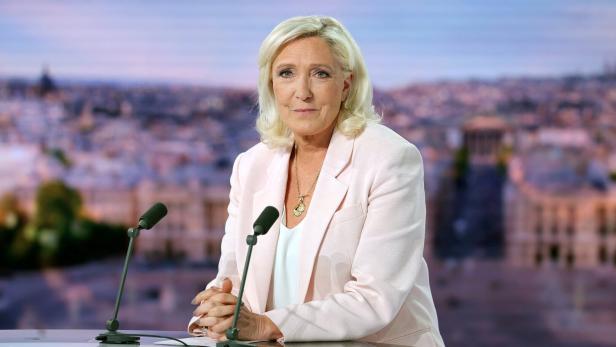 French far-right leader Le Pen reacts on TV after her appeal trial verdict