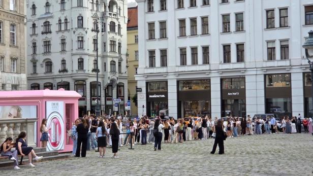 Menschen stehen am pinken Dior-Addict-Pop-up am Hohen Markt in Wien Schlange.
