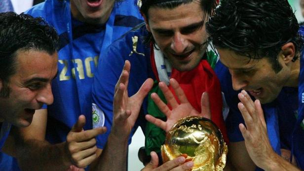 Italy players look at the World Cup Trophy after the World Cup 2006 final soccer match between Italy and France in Berlin