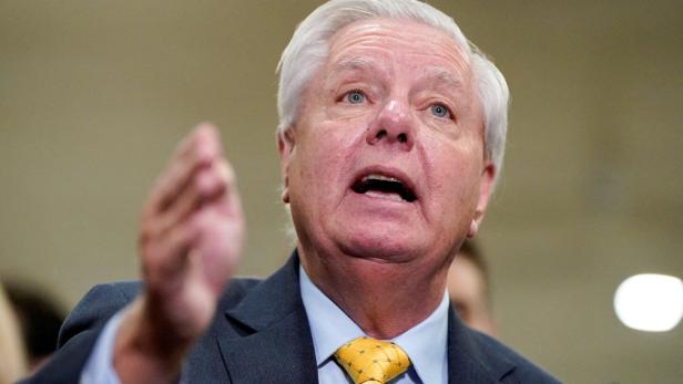 Der US-Senator Lindsey Graham spricht mit erhobener Hand und ernstem Gesichtsausdruck.