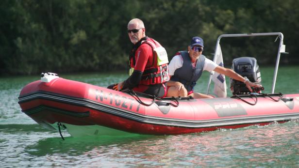 Wasserretter in einem roten Einsatzboot auf dem See.