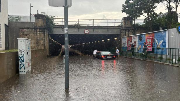 Überflutete Unterführung in der Mooslackengasse in Döbling, in der ein Auto im Starkregen feststeckt.