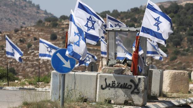 A cement block with the words 'no future' spraypainted on it in Arabic at an Israeli military checkpoint near Birzeit