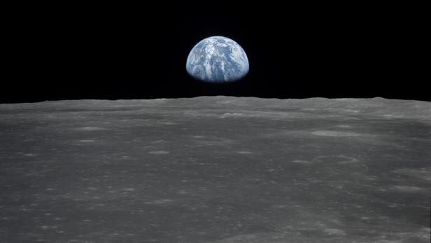 Apollo 11 Mission image - View of moon limb,with Earth on the horizon,Mare Smythii Region