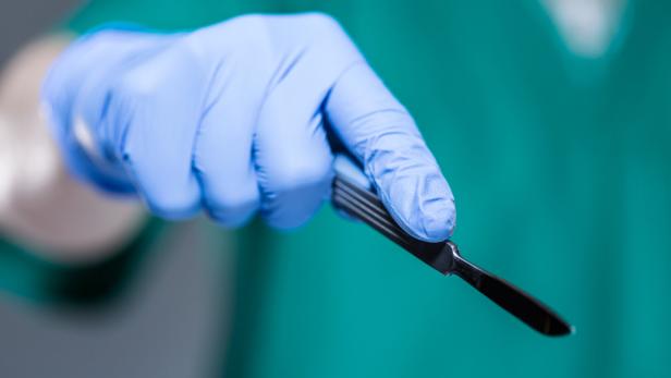 Hand of doctor holding scalpel