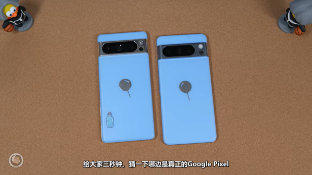 Zwei hellblaue Smartphones liegen mit dem Display nach unten auf einem Tisch