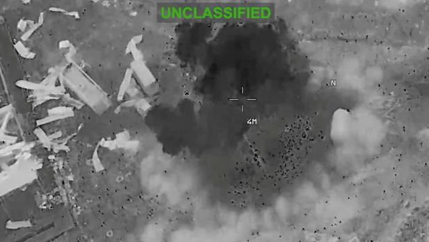 Scattered debris and smoke, at an unknown location, during what the U.S. Central Command (CENTCOM) says are strikes on Iran