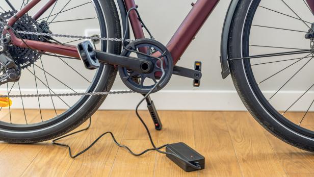 Electric Bicycle Charging Indoors at Home, Close-Up