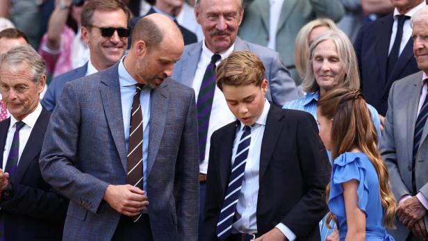 Prinz William und Prinz George unterhalten sich auf der Tribüne, während Prinzessin Charlotte neben ihnen steht.