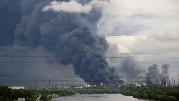 FILE PHOTO: Thick plumes of smoke with flames rise from an oil refinery following a Ukrainian drone attack in Moscow