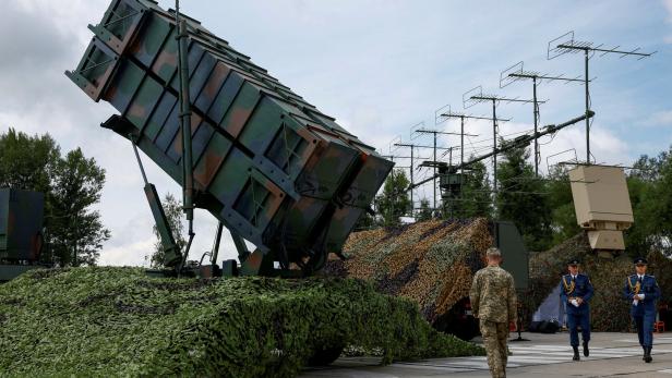 FILE PHOTO: Ukrainian service members walk next to a launcher of a Patriot air defence system an undisclosed location in Ukraine