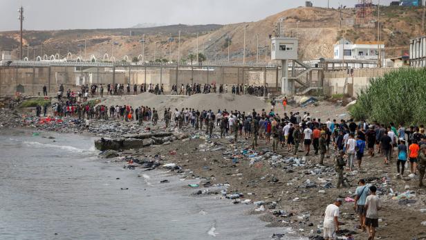 Migrants cross into the Spanish enclave of Ceuta