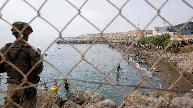 Migrants cross into the Spanish enclave of Ceuta