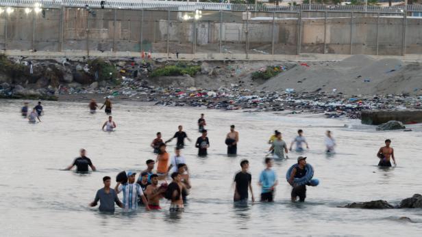 Migrants cross into the Spanish enclave of Ceuta