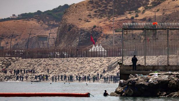 Mass crossings of migrants on foot and by sea from Morocco into Spanish territory, in Ceuta
