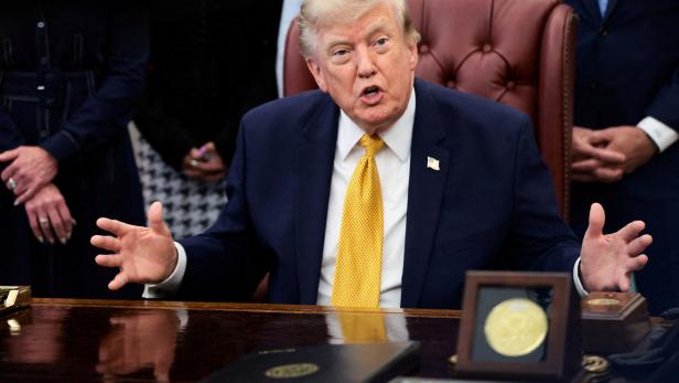 FILE PHOTO: U.S. President Donald Trump signs an executive order in the Oval Office at the White House in Washington