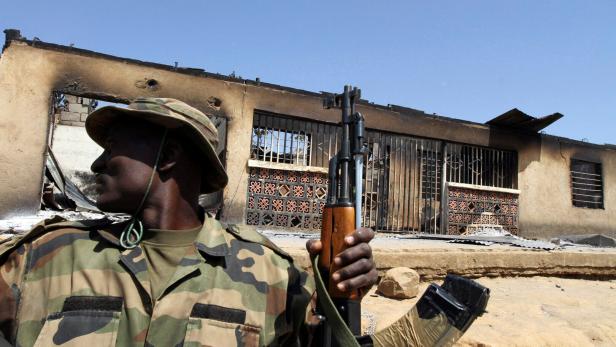 FILE PHOTO: A soldier sits in a truck during a military patrol in Nigeria's central city of Jos