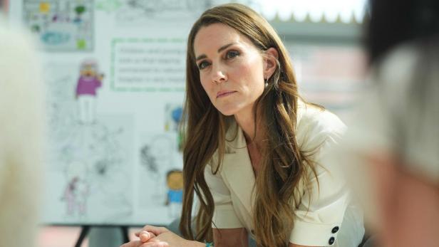 Catherine, Prinzessin von Wales, sitzt aufmerksam bei einer Besprechung vor einer illustrierten Tafel.