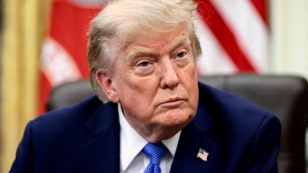 FILE PHOTO: U.S. President Donald Trump signs executive orders at the Oval Office in Washington