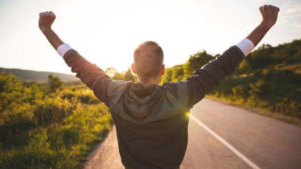 Man raising arms