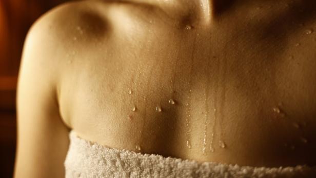 Young woman relaxing in hot sauna, closeup