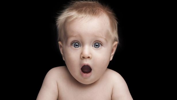 newborn baby portrait with funny shocked face expression