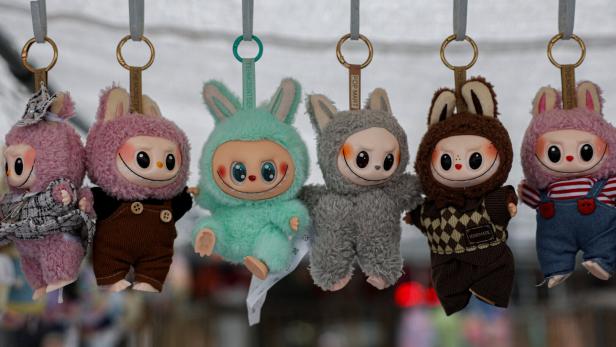 Counterfeit Labubu dolls are displayed by a street vendor in New York City