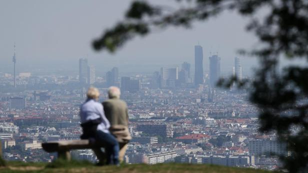 People enjoy a sunny spring day as they look down on the city of Vienna