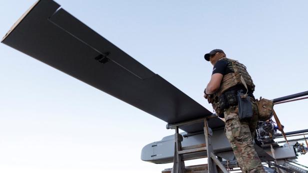 Ukrainian serviceman stands next to FP-1 deep-strike drones before their launch for a combat mission in an undisclosed location in Ukraine