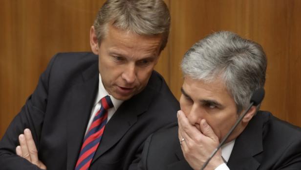Austrian Chancellor Werner Faymann (R) talks with State Secretary Reinhold Lopatka during a session of the parliament in Vienna April 21, 2010. REUTERS/Heinz-Peter Bader (AUSTRIA - Tags: POLITICS)