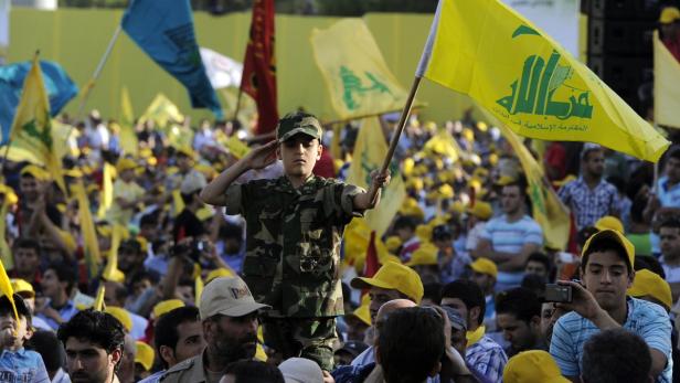 epa03717117 A Lebanese Shiite boy with a Hezbollah military uniform waves Hezbollah flag, during a rally to mark the Resistance and Liberation Day, in the village of Mashghara, in the eastern Bekaa valley, Lebanon, 25 May 2013. The Liberation Day commemorates the Israeli army&#039;s withdrawal from south Lebanon in May 2000 following 22 years of occupation. EPA/WAEL HAMZEH