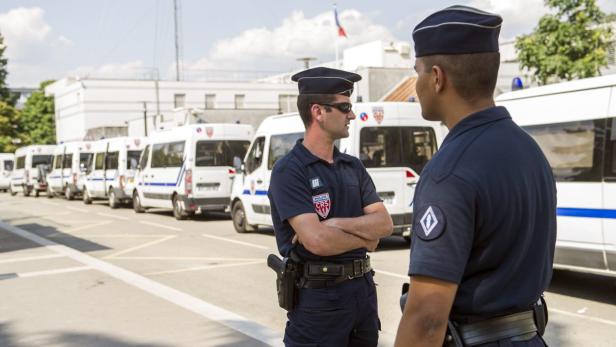 epa03795973 Policemen stand in front of the police station in the Parisian suburb of Trappes, France, 21 July 2013. According to media reports, the suburb has observed two nights of violence following the arrest of a man who allegedly attacked a police officer after his wife was asked to remove a face-covering Islamic veil, banned in public in secular France. EPA/ETIENNE LAURENT