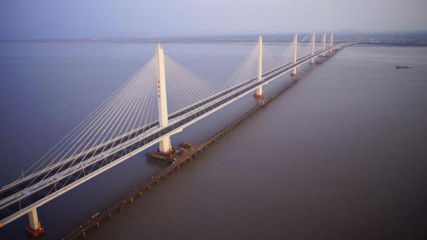 An aerial view shows the Jiashao Cross-Sea Highway Bridge connecting Jiaxing and Shaoxing across the estuary of Qiantang River, Zhejiang province June 17, 2013. The 10,137 metres (6.3 miles) highway bridge, the longest and widest multiple-span cable-stayed bridge in the world, will be opened at midnight this Friday, local media reported. Picture taken June 17, 2013. REUTERS/China Daily (CHINA - Tags: TRANSPORT) CHINA OUT. NO COMMERCIAL OR EDITORIAL SALES IN CHINA