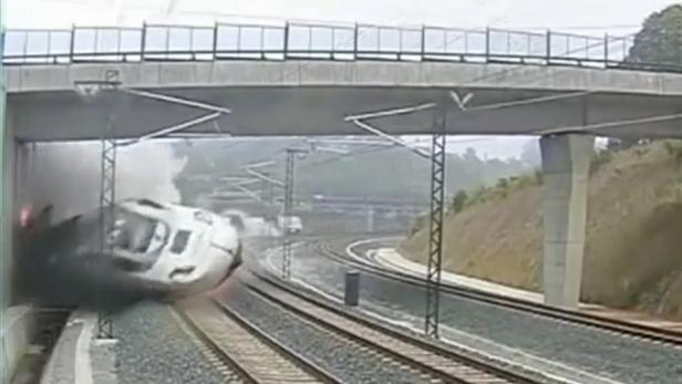 Ein entgleister Zug liegt unter einer Brücke.