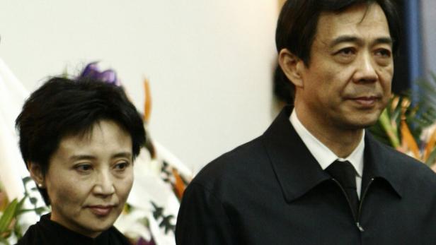 China&#039;s former Chongqing Municipality Communist Party Secretary Bo Xilai (R) and his wife Gu Kailai stand at a mourning held for his father Bo Yibo, former vice-chairman of the Central Advisory Commission of the Communist Party of China, in Beijing in this January 17, 2007 file photo. China holds its most sensational trial this week since convicting the Gang of Four over 30 years ago, putting Gu Kailai, the wife of deposed leader Bo Xilai, in the dock for murder. Legal experts and activists expect her to receive the kind of rapid guilty verdict handed down in almost all Chinese criminal trials - the kind Gu once compared favourably to the United States where she felt the guilty risked going free on legal technicalities. Picture taken January 17, 2007. REUTERS/Stringer/Files (CHINA - Tags: CRIME LAW POLITICS) CHINA OUT. NO COMMERCIAL OR EDITORIAL SALES IN CHINA
