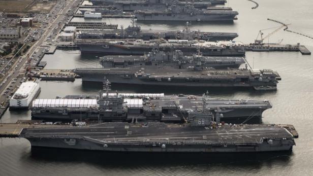The aircraft carriers USS Dwight D. Eisenhower (CVN 69), USS George H.W. Bush (CVN 77), USS Enterprise (CVN 65), USS Harry S. Truman (CVN 75), and USS Abraham Lincoln (CVN 72) are pictured in port at at Naval Station Norfolk, Virginia, in this handout photograph taken on December 20, 2012 and obtained on February 22, 2013. Pentagon civilian and military leaders have warned they will be forced to slash ship and aircraft maintenance and curtail training, if across-the-board cuts to the U.S. Defense budget go into effect on March 1. REUTERS/Ryan J. Courtade/U.S. Navy/Handout (UNITED STATES - Tags: MILITARY POLITICS) ATTENTION EDITORS - THIS IMAGE WAS PROVIDED BY A THIRD PARTY. FOR EDITORIAL USE ONLY. NOT FOR SALE FOR MARKETING OR ADVERTISING CAMPAIGNS