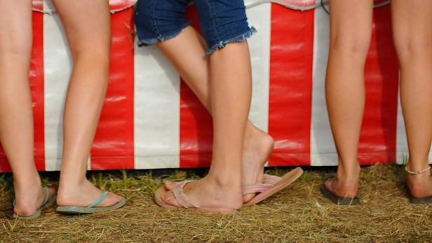 epa02297933 (11/16) Girls in denim shorts and flip flop sandals at a carnival game booth at the 2010 Martha&#039;s Vineyard Agricultural Society Fair on the island of Martha&#039;s Vineyard in West Tisbury, Massachusetts, USA 21 August 2010. Thousands of Martha&#039;s Vineyard residents and summer visitors are attracted to the Martha&#039;s Vineyard Agricultural Society annual Agricultural Fair held in August in West Tisbury. The four-day fair highlights the raising of livestock, including fowl, cattle sheep, and horses; competitions in log rolling, axe, handsaw and chainsaw use; and showcases artisan crafts such as weaving and yarn production. Fair-goers ride carnival rides into the summer night and treat themselves to cotton candy, candied apples, fried dough and fresh corn-on-the-cob. EPA/CJ GUNTHER