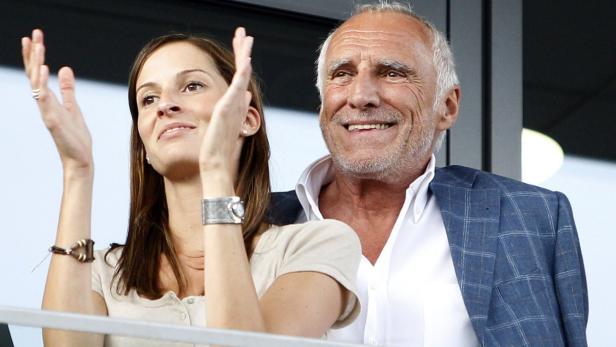 Red Bull owner Dietrich Mateschitz (R) and an unidentified woman watch the opening of the &quot;Red Bull Ring&quot; motorsport race circuit in Spielberg, May 14, 2011. REUTERS/Lisi Niesner (AUSTRIA - Tags: SPORT MOTOR RACING)