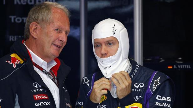 Red Bull Formula One driver Sebastian Vettel (R) of Germany talks to Red Bull head of motorsports Helmut Marko as he prepares for the first practice session of the German F1 Grand Prix at the Nuerburgring racing circuit, July 5, 2013. REUTERS/Kai Pfaffenbach (GERMANY - Tags: SPORT MOTORSPORT F1)