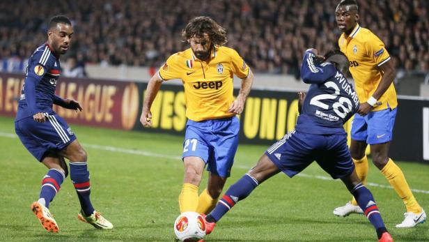 Olympique Lyon's Mvuemba challenges Pirlo of Juven