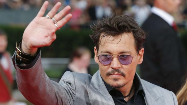 Cast member Depp arrives on red carpet to promote