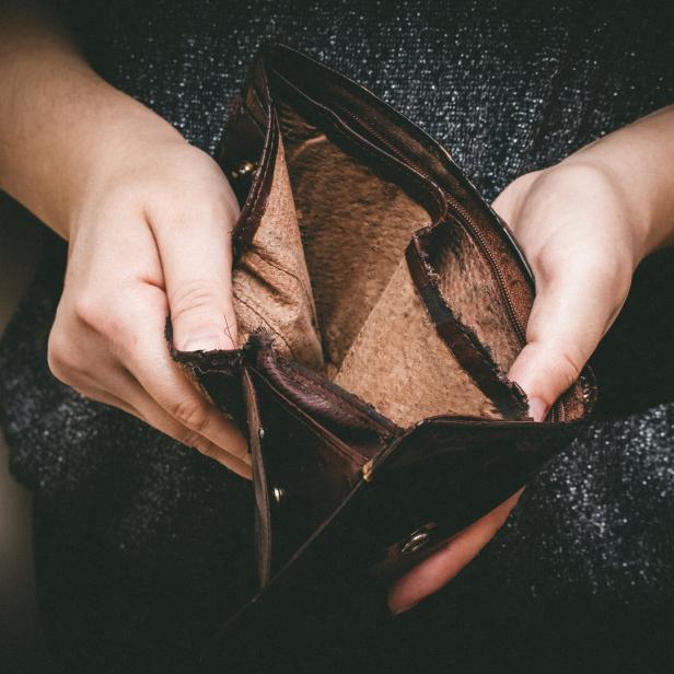Old empty wallet in the hands .Vintage empty purse in hands of women . Poverty concept, Retirement. Special toning
