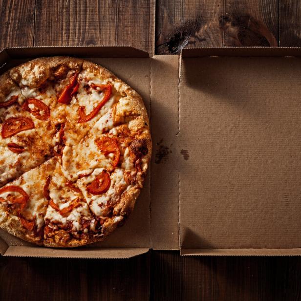 pizza in the in delivery box on the wood
