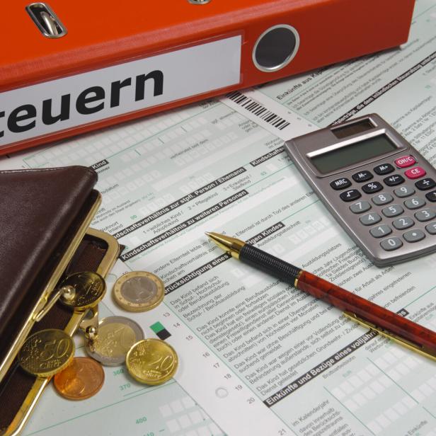 tax form and ring binder with print tax on it - in German language: Steuern