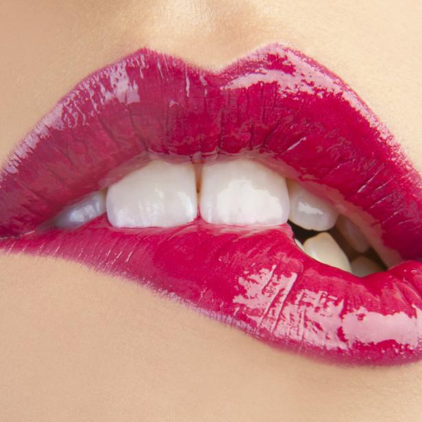 Close up of woman biting her lip