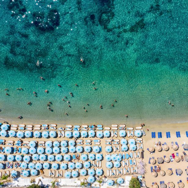Aerial top down view to the famous beach of Psarou on Mykonos island