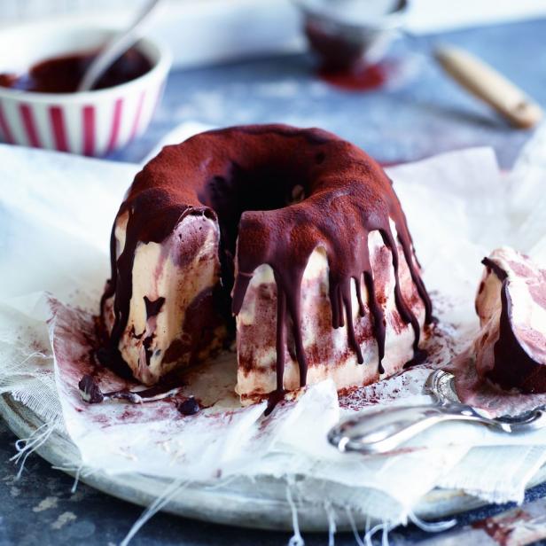 Ein Gugelhupf-Eisdessert mit Schokoladenglasur und Kakaopulver bestreut.
