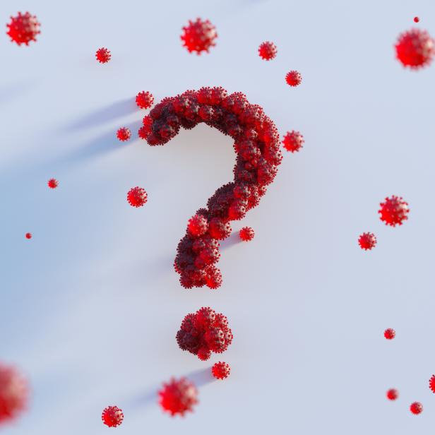 Ein Fragezeichen, geformt aus roten Coronavirus-Darstellungen.